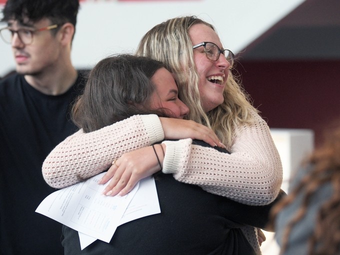 Two people hugging happily