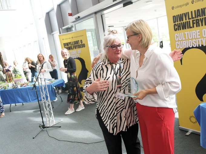 Heidi being awarded with teaching and learning award by executive at teaching and learning awards