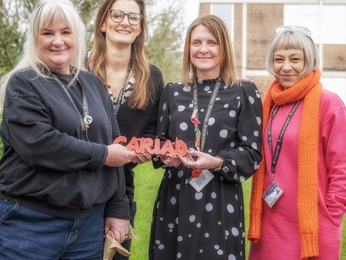 Jamie Hawkins being awarded cariad award by 3 other female staff members