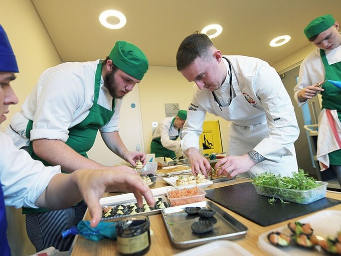 Students working in the Senedd kitchen