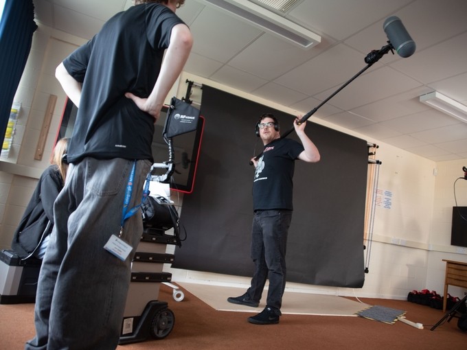 A student holding an extended mic