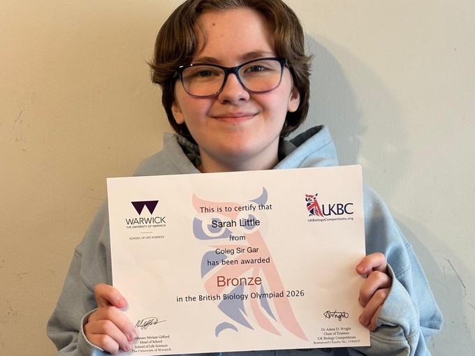 Sarah 'Asher' Little holding up her Olympiad bronze certificate