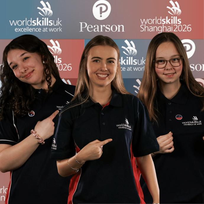 The three girls pointing to the WorldSkills logo on their tops with a branded WorldSkills and Pearson background