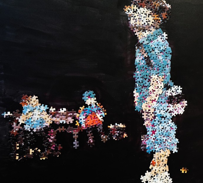 A piece made up of jigsaw pieces it's a person