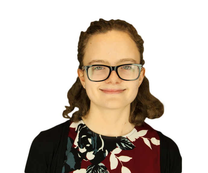 A picture of Victoria wearing a black cardigan and maroon/black/white pattered top