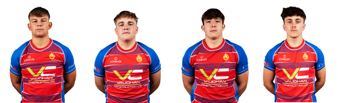 A row of rugby players facing the camera white background wearing blue and red Vaughan Construction shirts