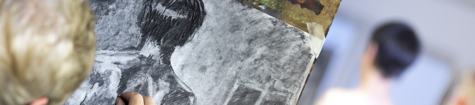 A student works with charcoal.