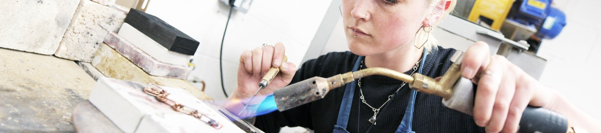 A student making jewellery. 