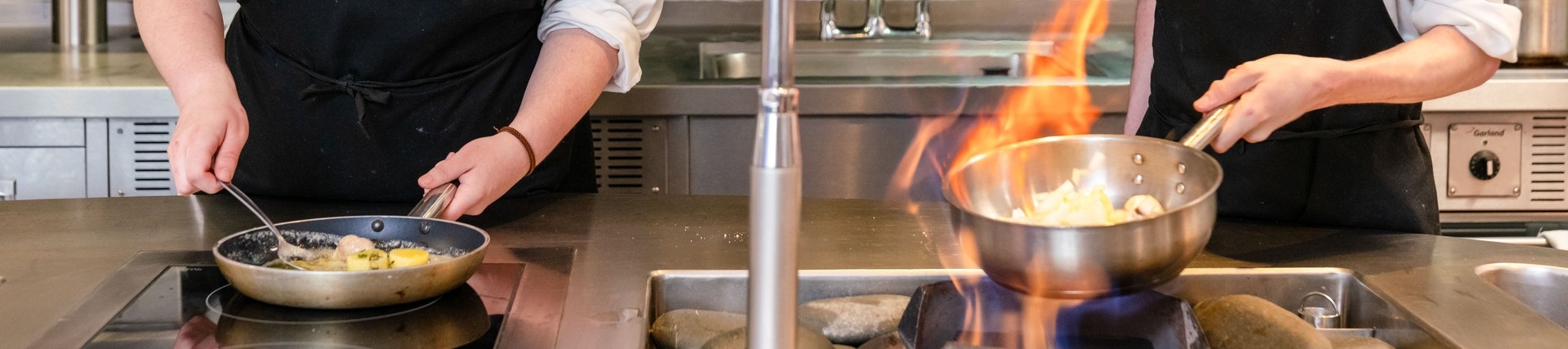 Two students cooking in kitchen 