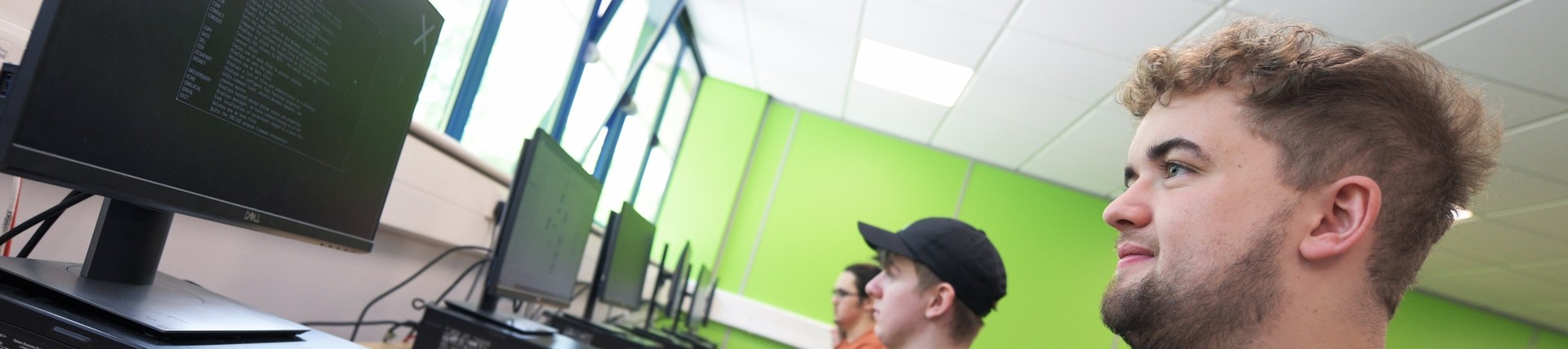 A student coding on a computer.