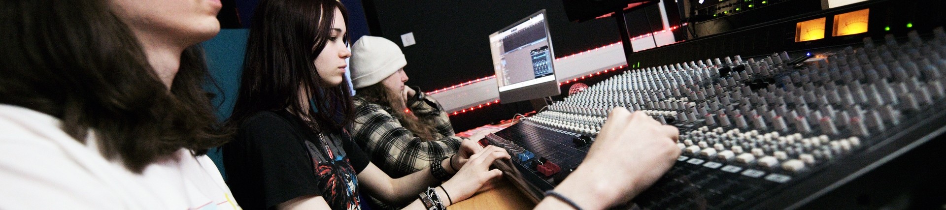 A student using a mixing desk.
