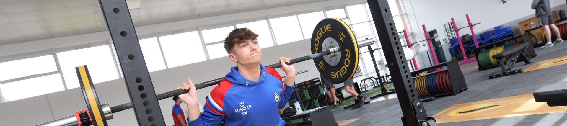 A student lifting weights.