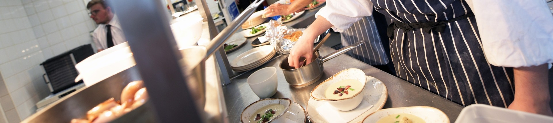 A student plates a dish.