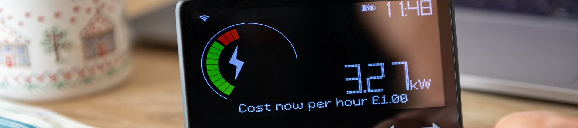 The hand of unseen person using a smart meter