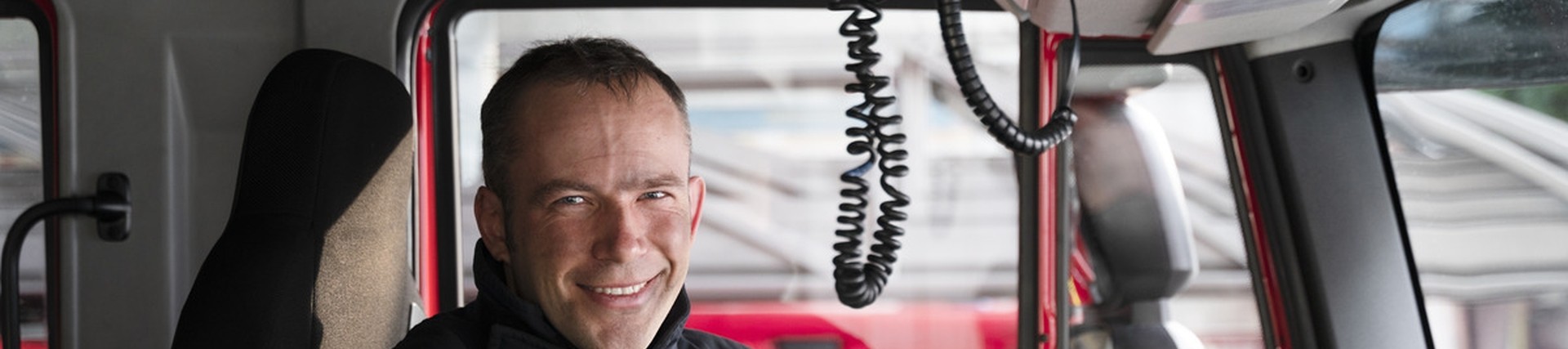 Man inside fire truck in uniform