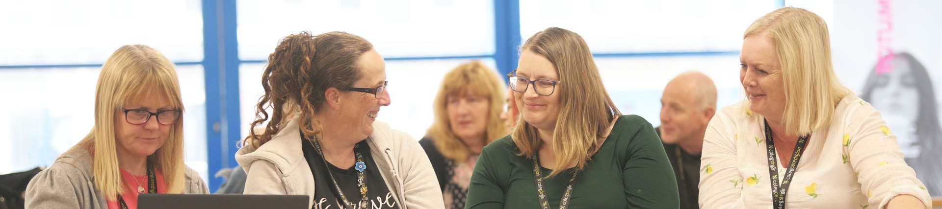 Four female teachers sat discussing