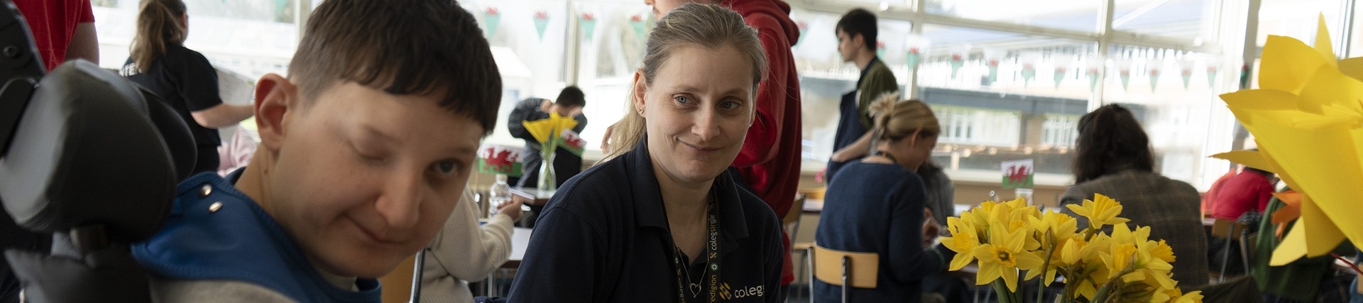 A student looks at the camera from a food table