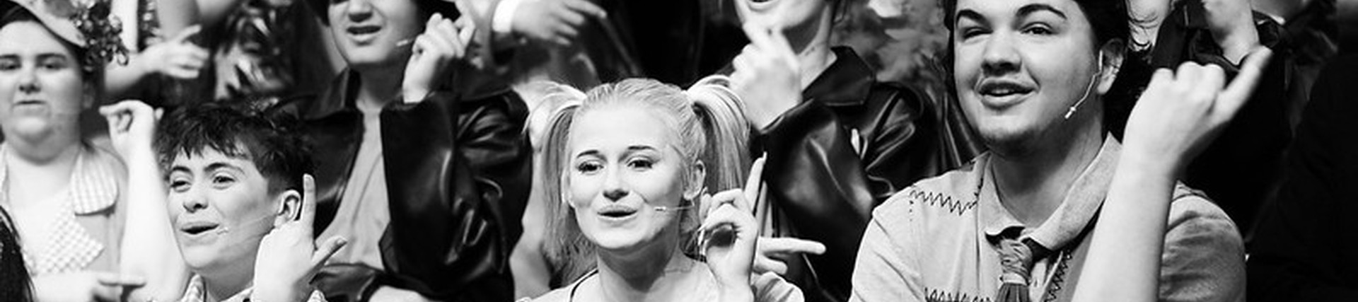 black and white photo of an ensemble dancing in a performance of Suessical