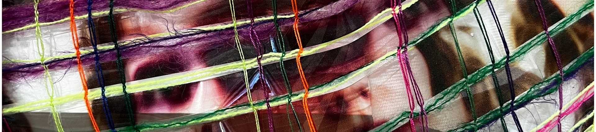 fabric made out of neon colours with creepy ripped faces in the pattern