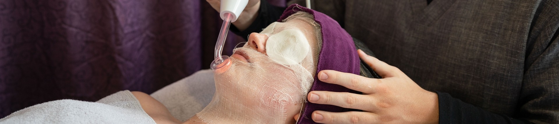 student delivering an aesthetic facial therapy