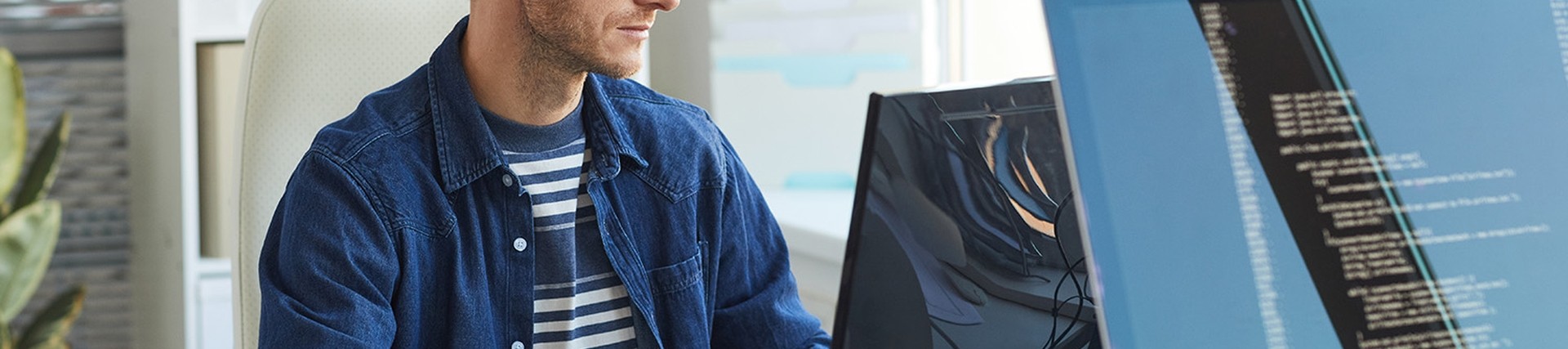 Person with glasses working on a computer