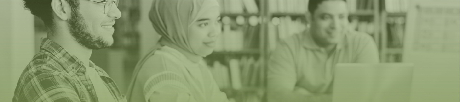 Image of three diverse people in a library