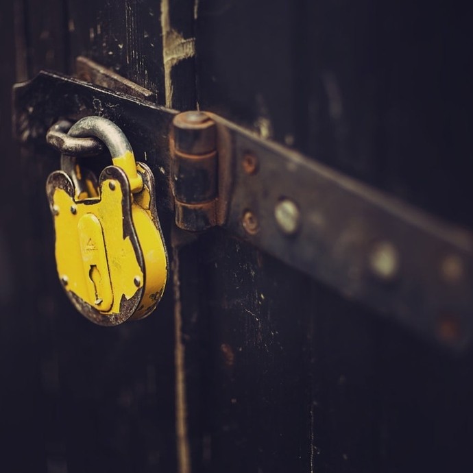 A yellow padlock securing a door