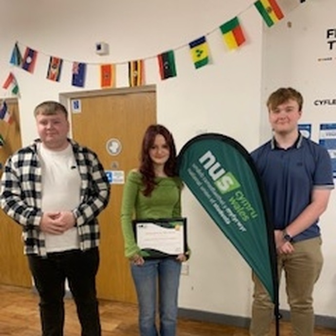 Three members of the student union holding their award certificate.