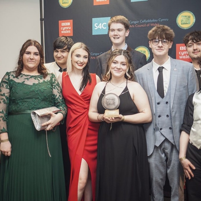 group of winner holding award