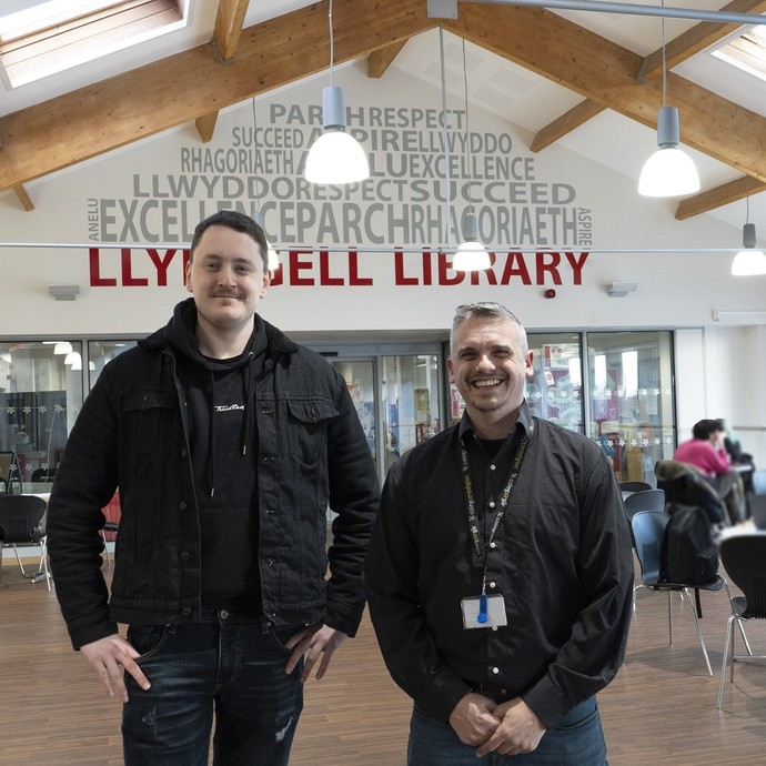 Alex and Nick's tutor standing near Starbucks and the library