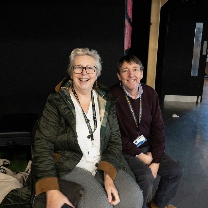 Two tutors from Coleg Ceredigion sitting down happily looking at the camera