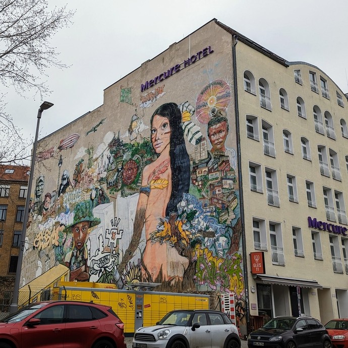 A hotel building with a creative mural down the side
