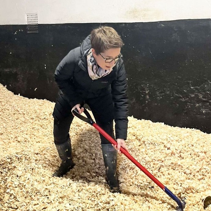Alex the tutor sweeps hay in horses