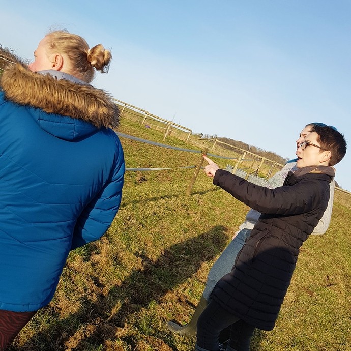 Alex the tutor out in the field with a student