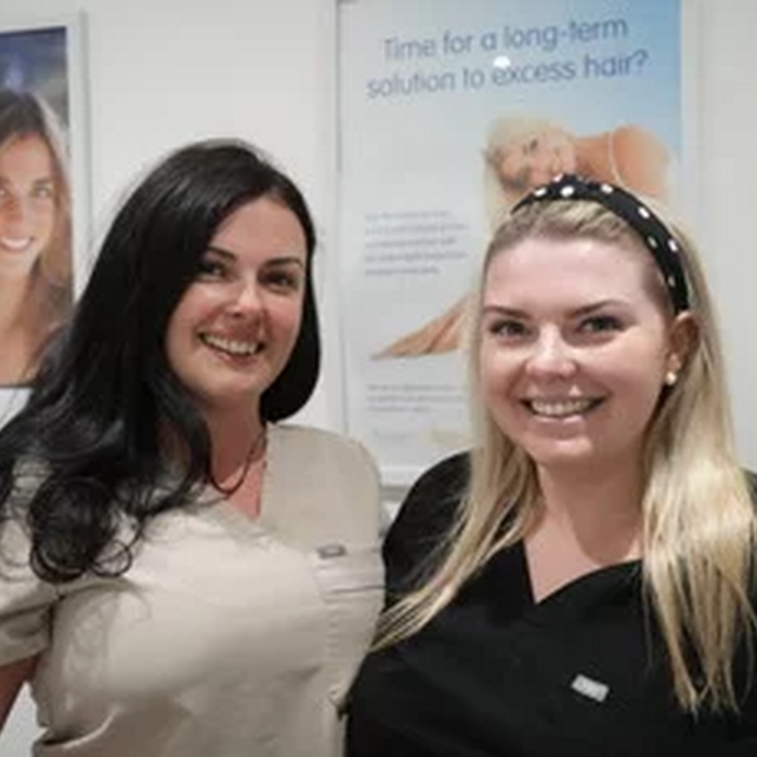 Pictured at her salon with posters in the background