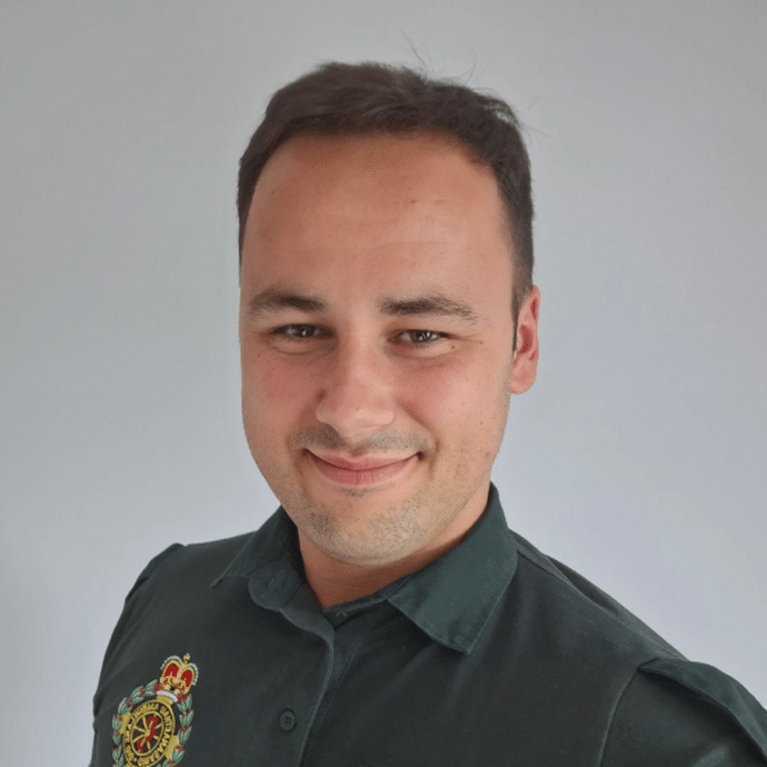 A headshot in his NHS green uniform