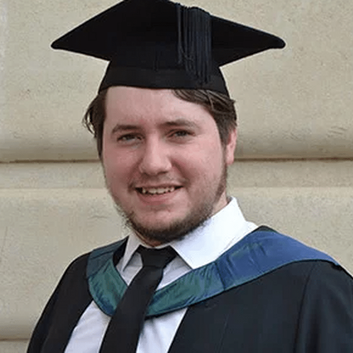 A head shot in a graduate gown and cap