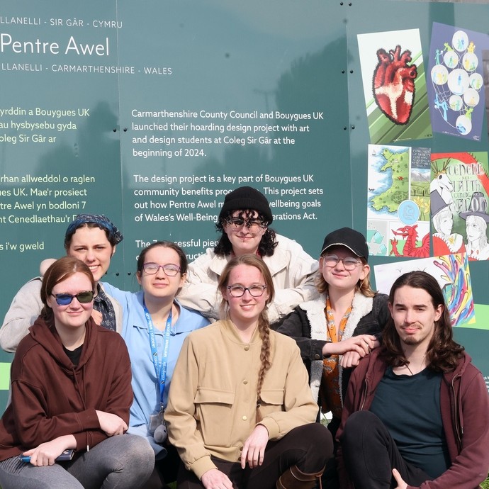 a group standing in front of the designs outside