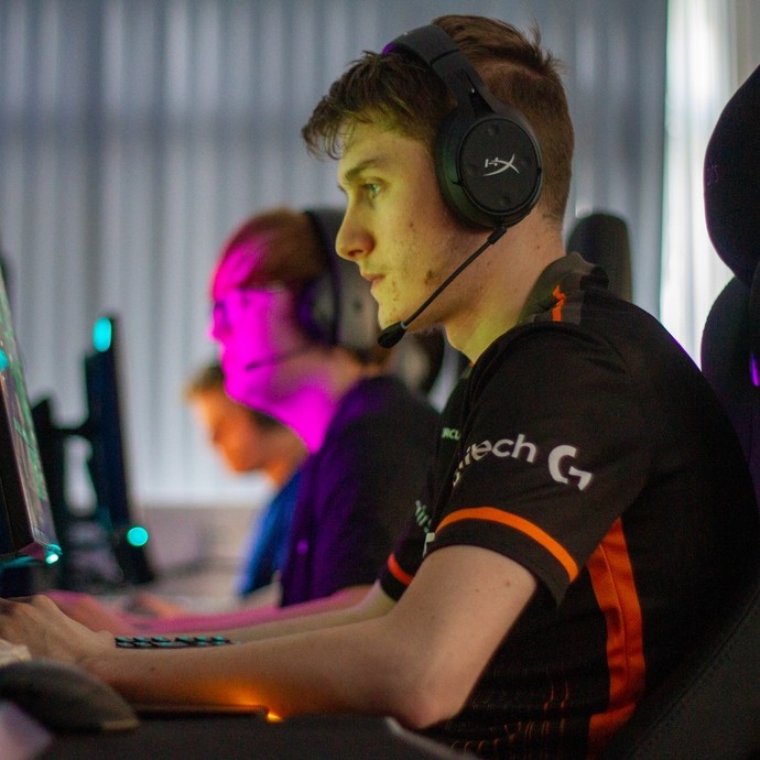 Student at a gaming computer wearing a headset