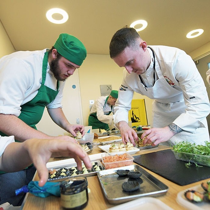 Students working in the Senedd kitchen