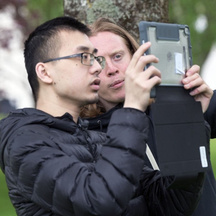 2 boys looking at an ipad