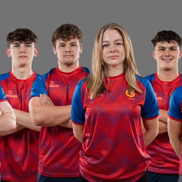 Six students lined up in their red and blue rugby kits