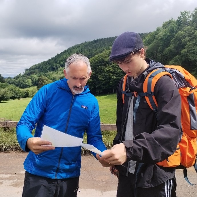 Lecturer Steve Bird helping a student with navigation and a map