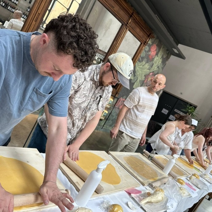 Students in a row taking part in a pasta making workshop with Dan their tutor