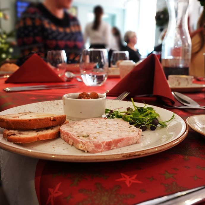 A starter dish of pate on a laid Christmas table