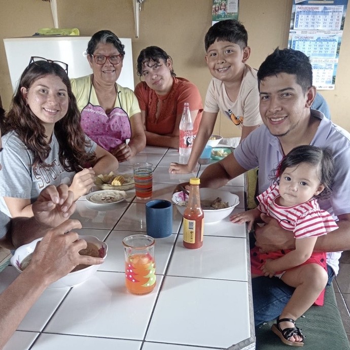 Hannah with her Costa Rican family round a table