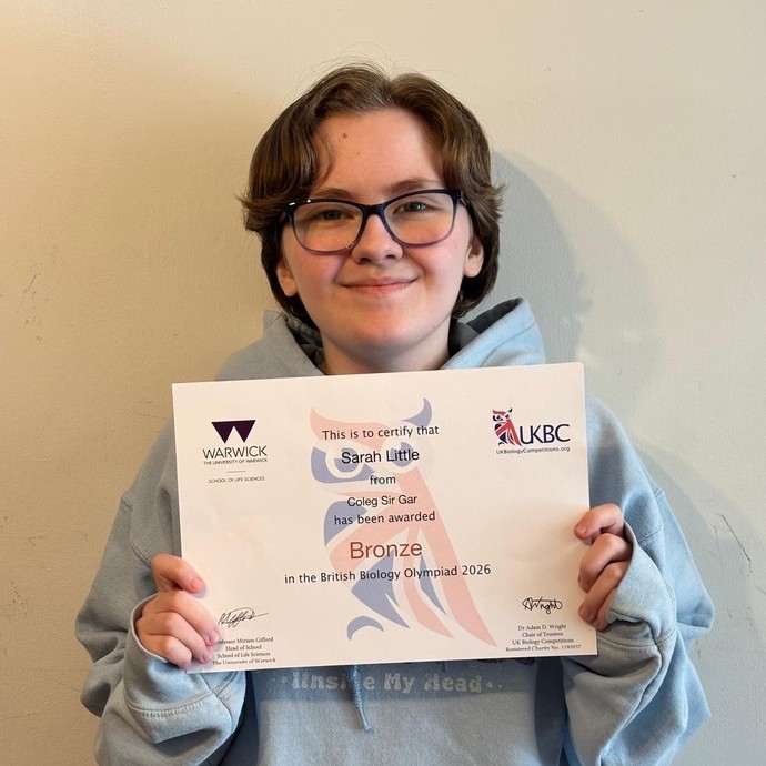 Sarah 'Asher' Little holding up her Olympiad bronze certificate
