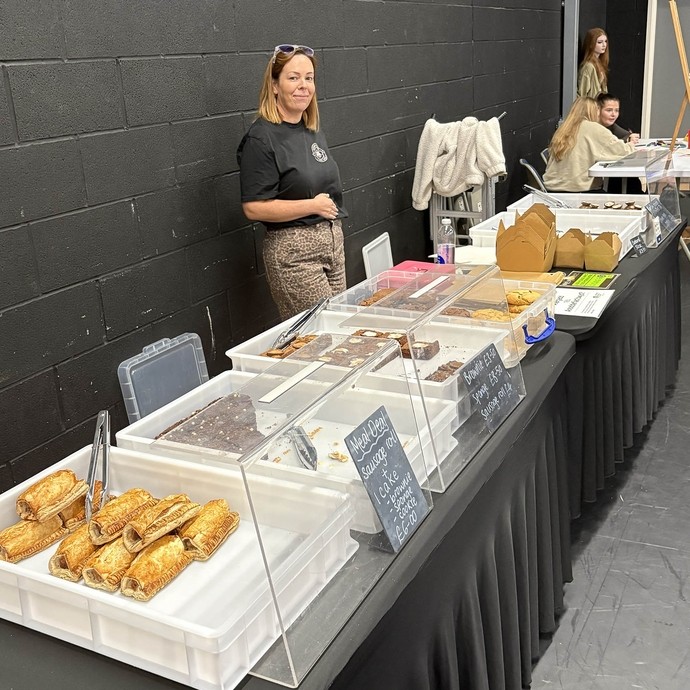 A lady from the baking company and her produce